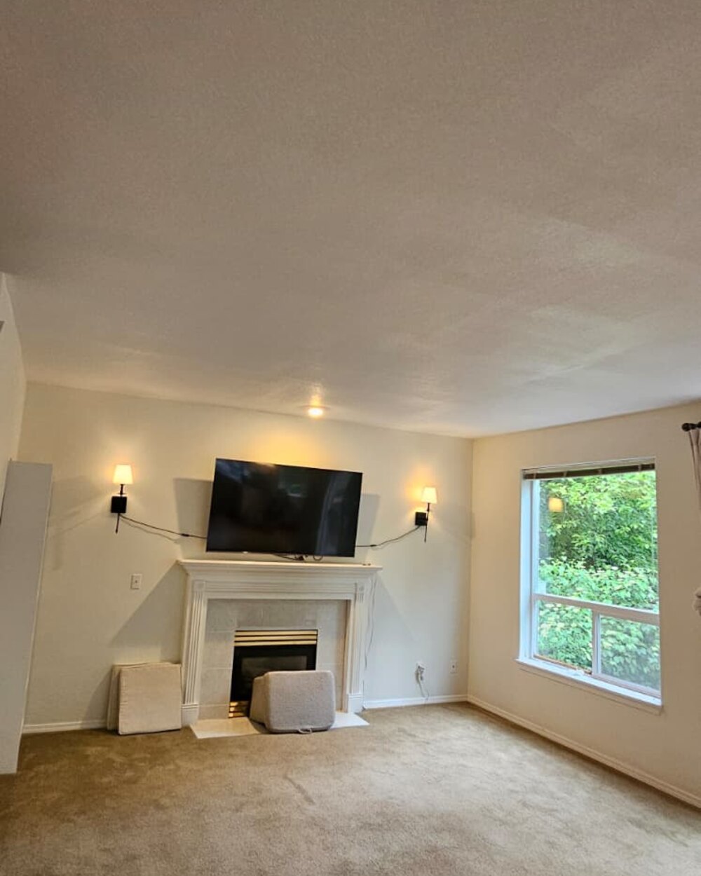 Finished living room with fireplace and painted walls